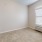 a room with a window and a carpet