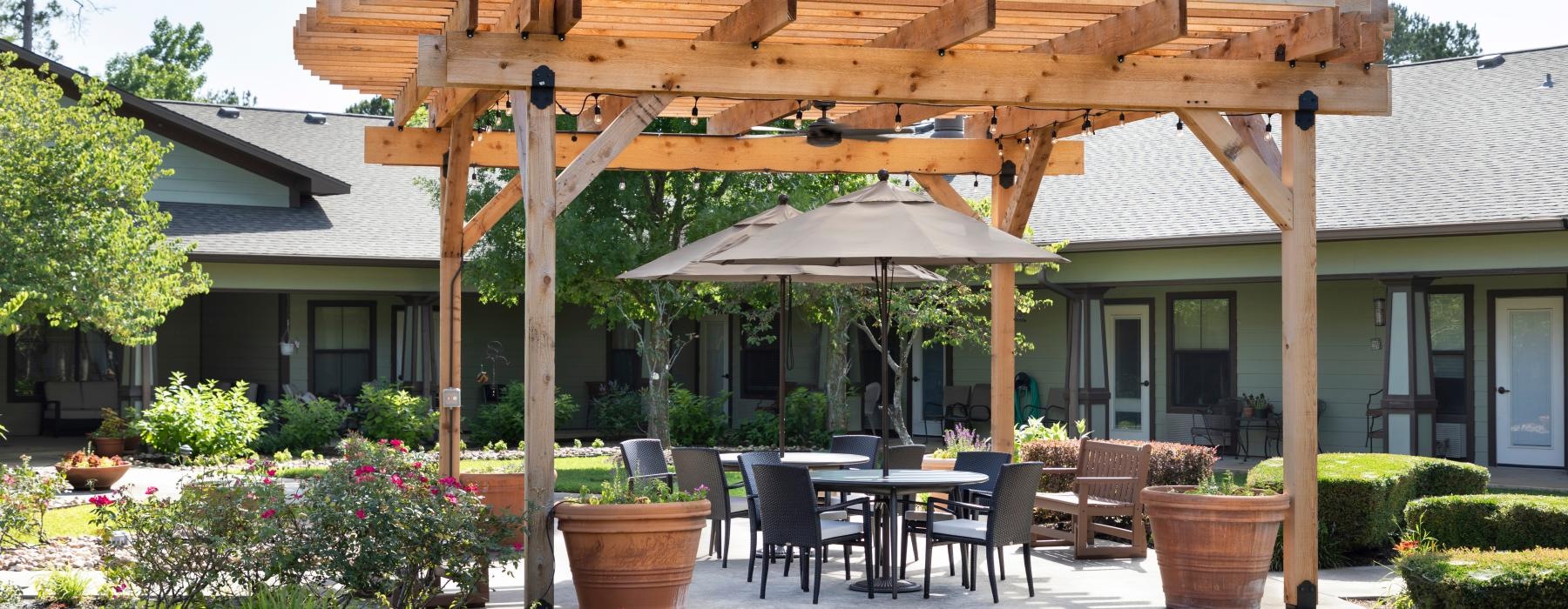 a patio with a table and chairs and umbrellas