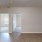 a room with a wood floor and white walls