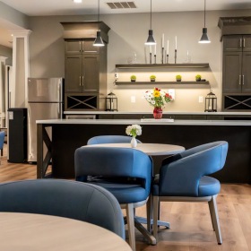 Elegance everywhere you look a lounge with seating and kitchen
