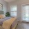 a bedroom with a bed and a plant
