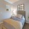 a bedroom with a bed and a plant